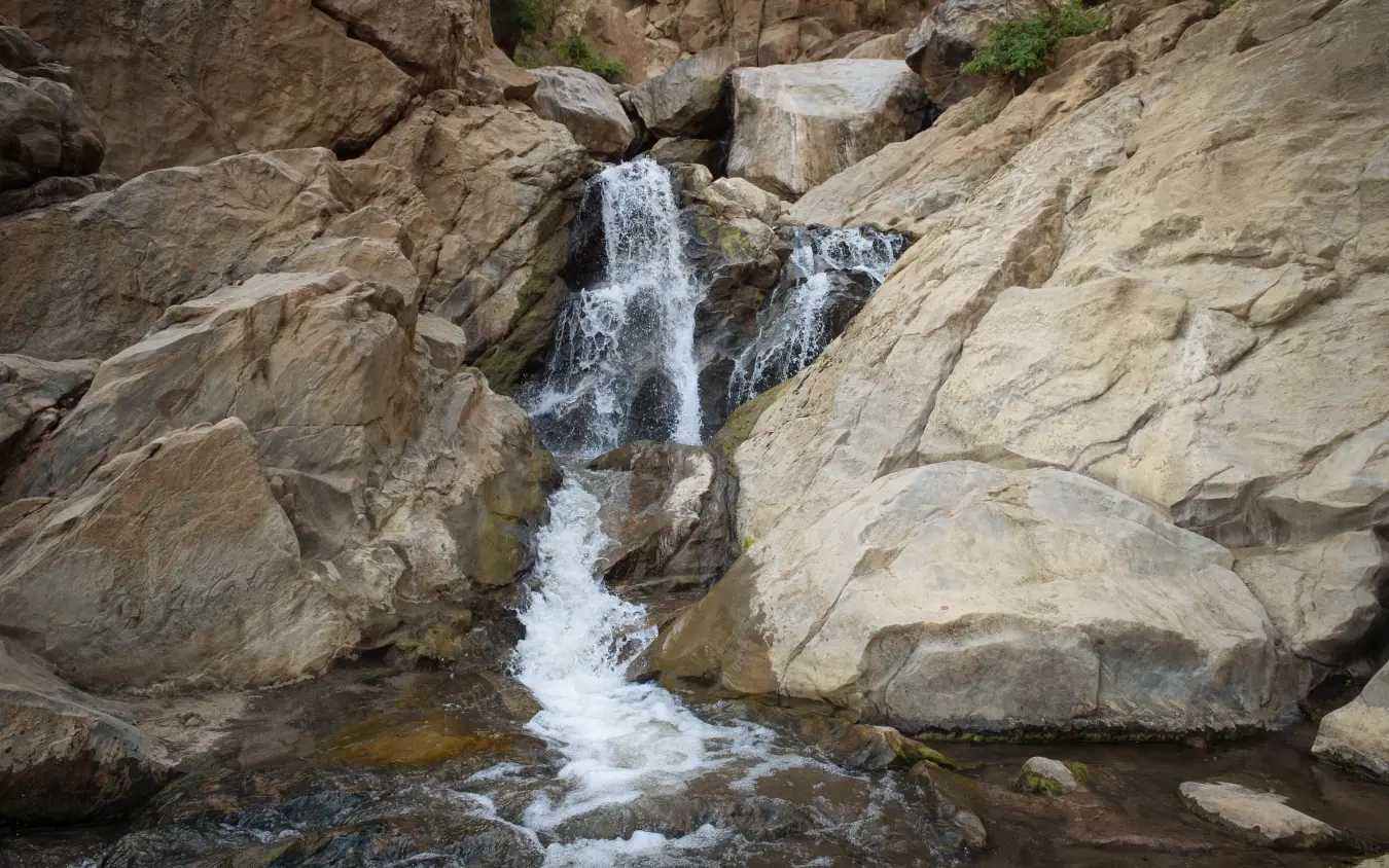 Waterfall cascading over rocky terrain in natural gorge, Manyara Green Camp, Lake Manyara, Tanzania