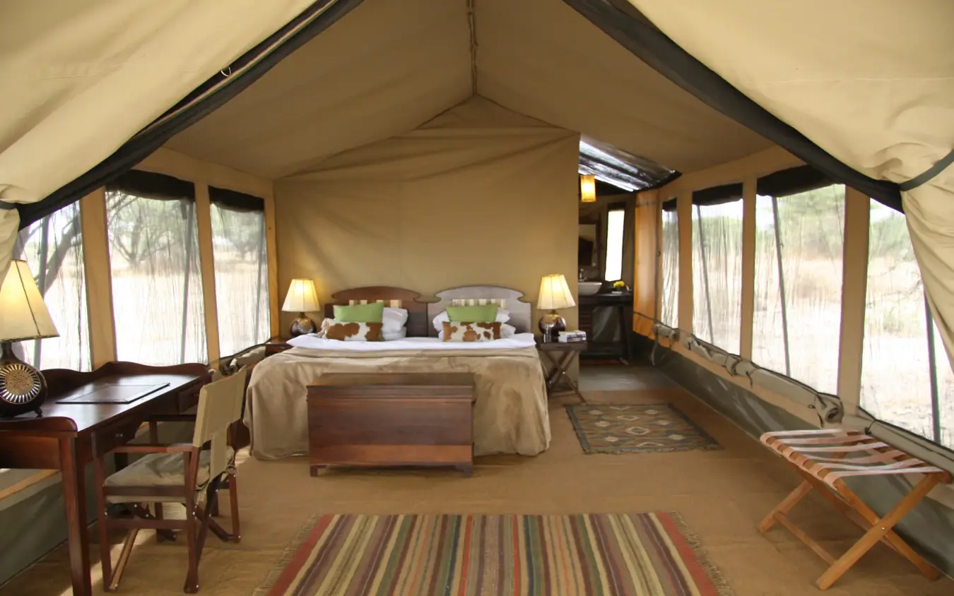 Luxury canvas safari tent interior with bed and canvas windows, Manyara Ranch, Lake Manyara, Tanzania
