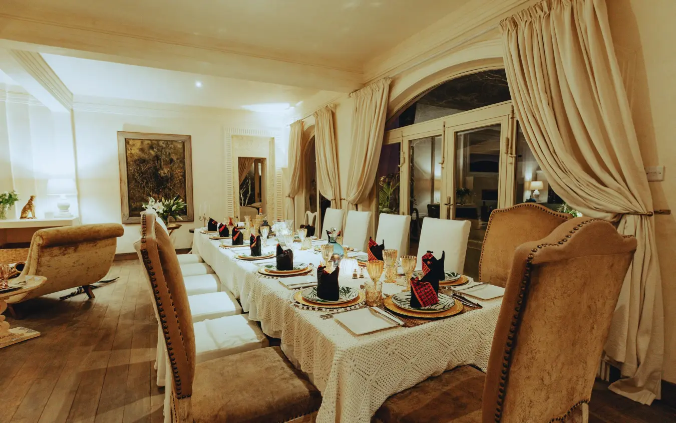 Elegant dining room with formal place settings and draped windows, Manzili House, Nairobi, Kenya