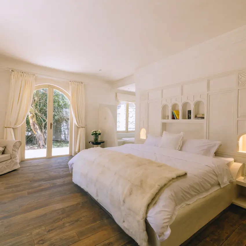 Spacious bedroom with bed, seating area, and garden doors, Manzili House, Nairobi, Kenya