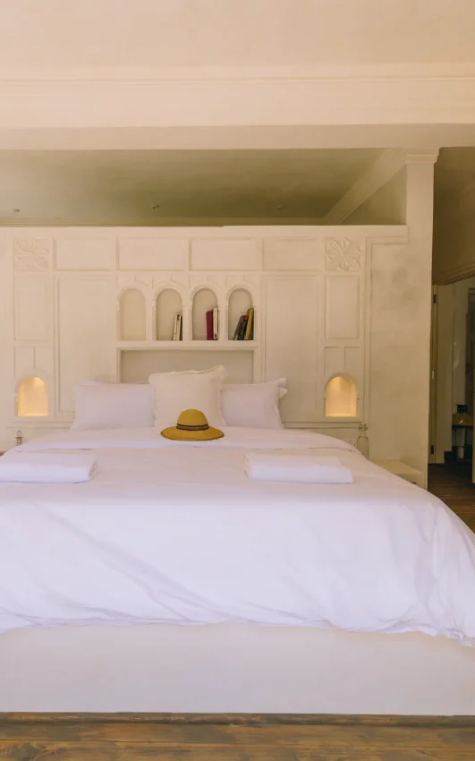 Spacious bedroom with white bedding and built-in cabinetry, Manzili House, Nairobi, Kenya