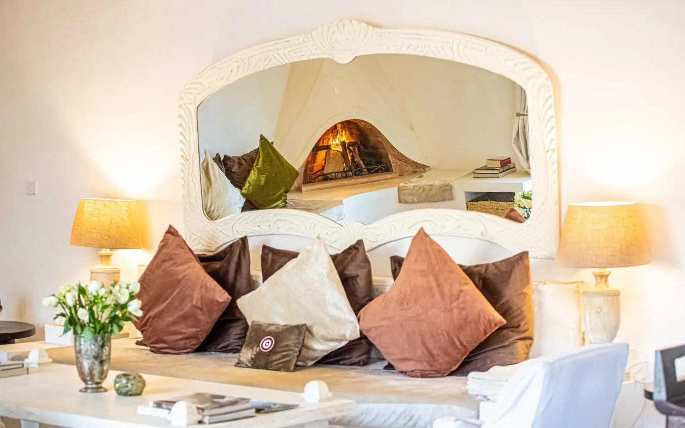 Bedroom with curved headboard alcove and cushioned seating area, Manzili House, Nairobi, Kenya