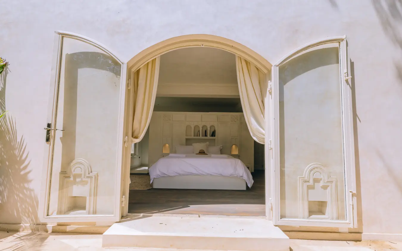 Bedroom entrance with arched doorway and white curtains, Manzili House, Nairobi, Kenya