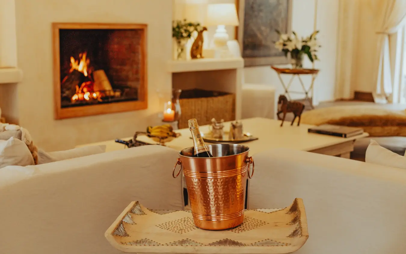Fireplace lounge with champagne bucket and decorative details, Manzili House, Nairobi, Kenya