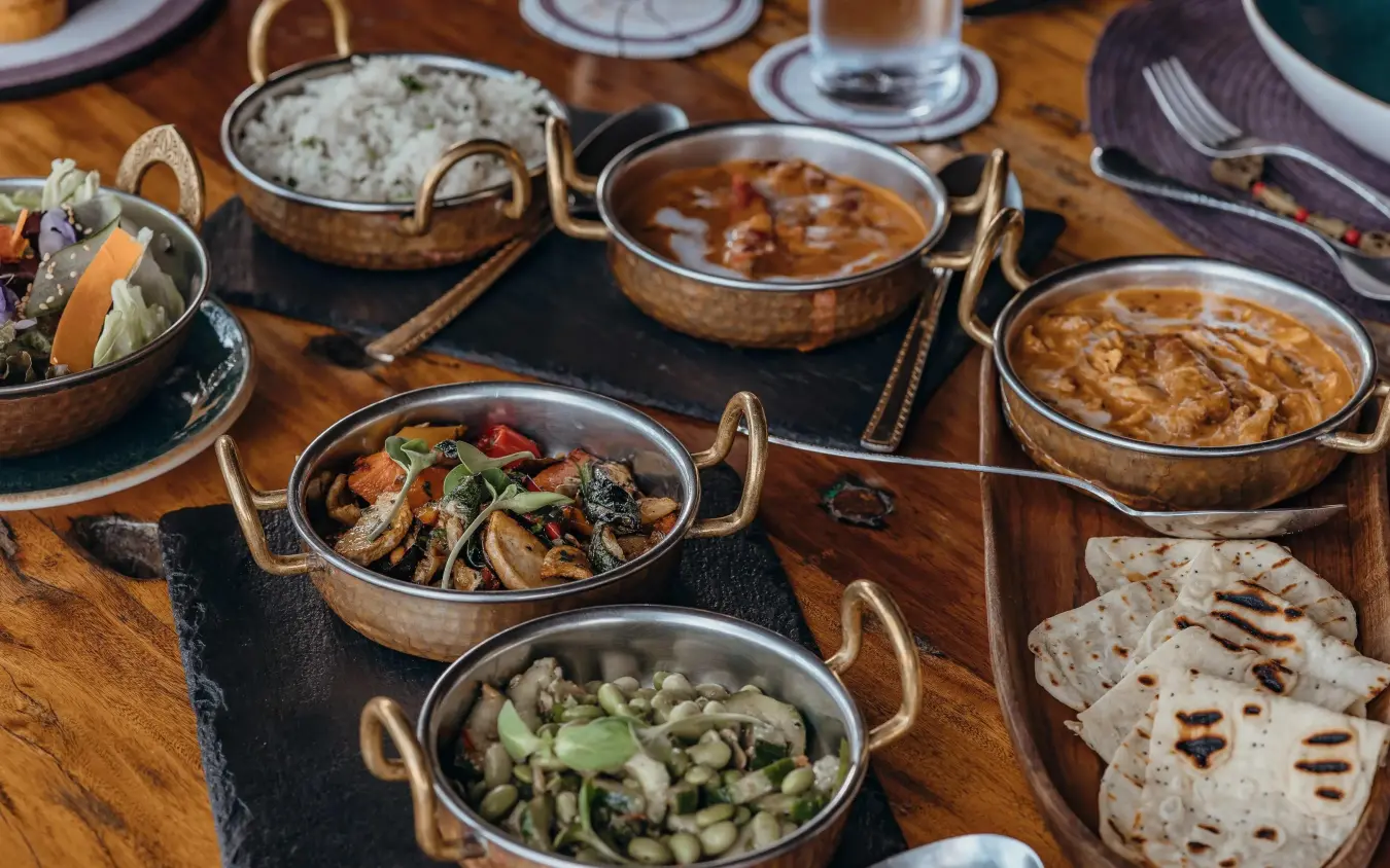 Multiple curry dishes served in traditional brass bowls, Mara Nyika Camp, Maasai Mara, Kenya