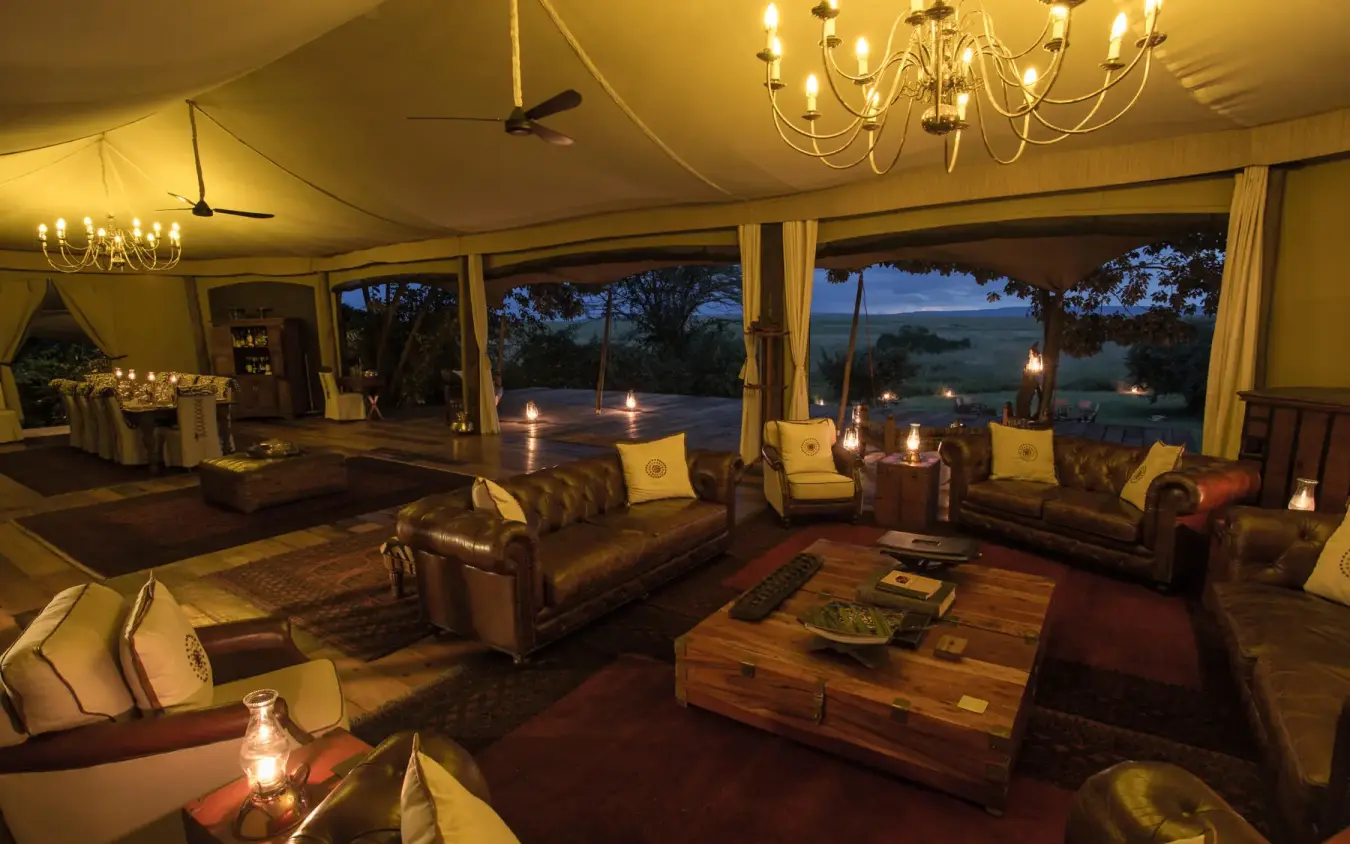 Luxury lounge with leather seating and expansive evening views, Mara Plains Camp, Maasai Mara, Kenya