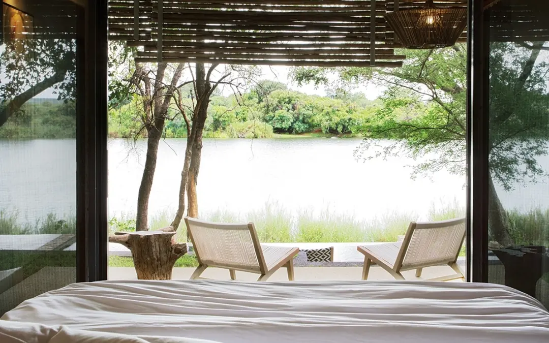 Bedroom with river view through open glass doors, Matetsi River Lodge, Victoria Falls, Zimbabwe