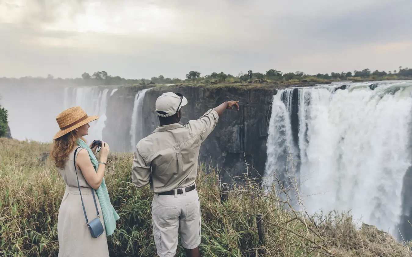 Guests viewing Victoria Falls from cliff edge viewpoint, Matetsi River Lodge, Victoria Falls, Zimbabwe