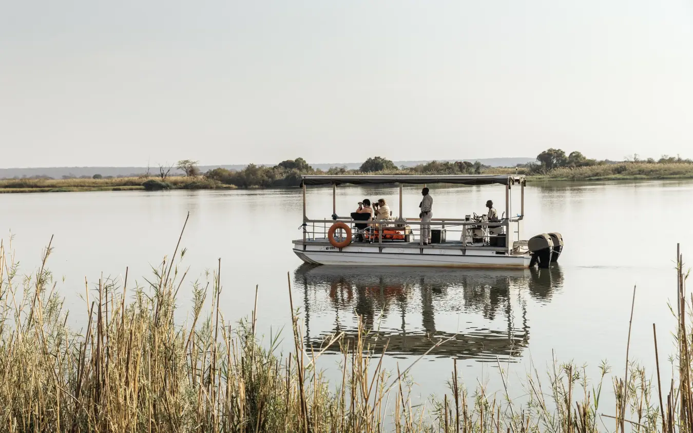 Guests on shallow-draft boat in wetland waterway