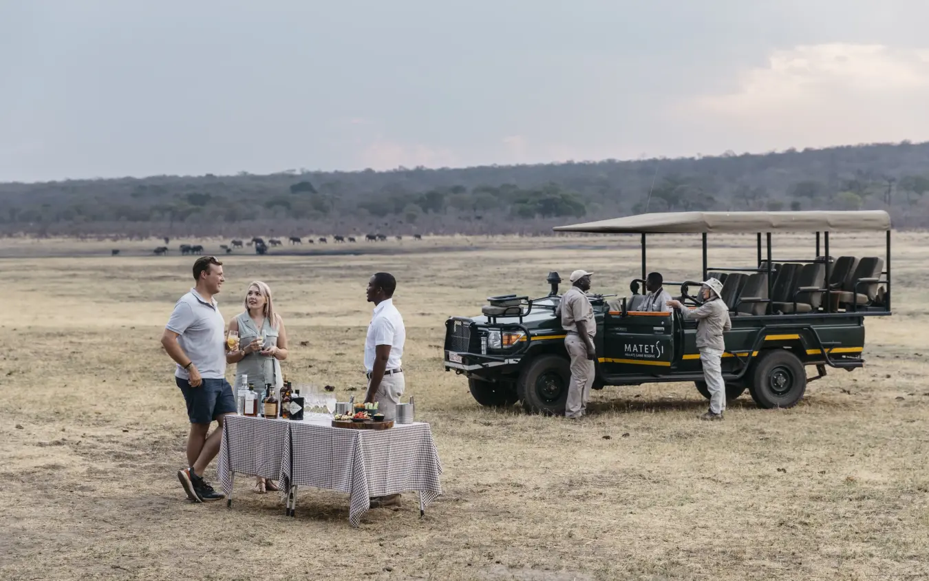 Guests enjoying refreshments during safari game drive, Matetsi River Lodge, Victoria Falls, Zimbabwe