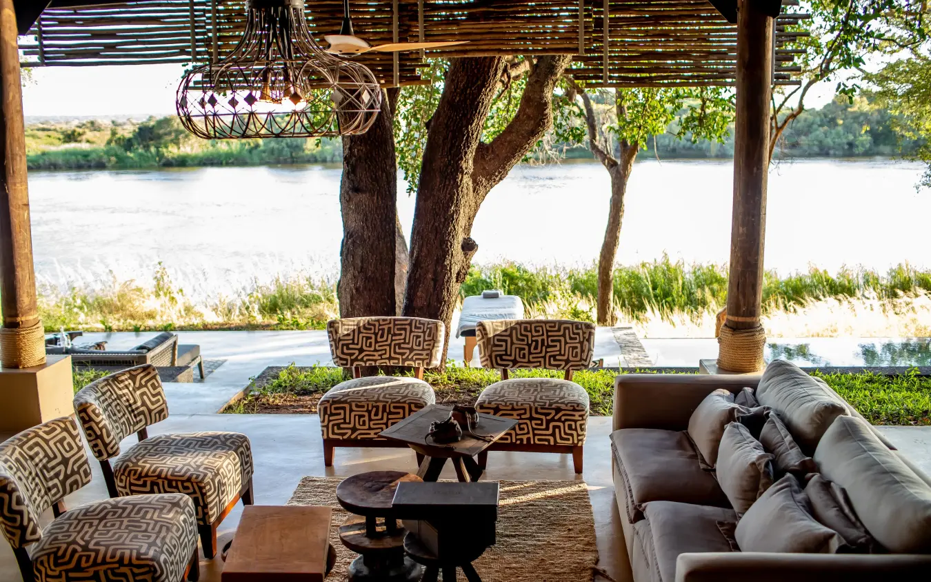 Riverside lounge with comfortable seating overlooking water, Matetsi River Lodge, Victoria Falls, Zimbabwe