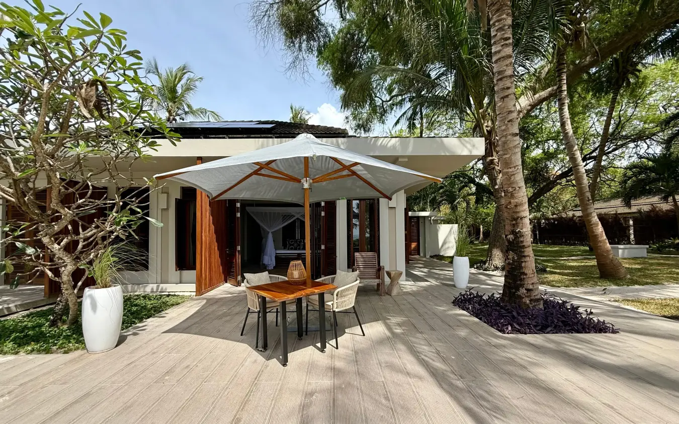 Modern beachfront villa with umbrella and wooden deck surrounded by palms, Maya Kobe, Kilifi, Kenya