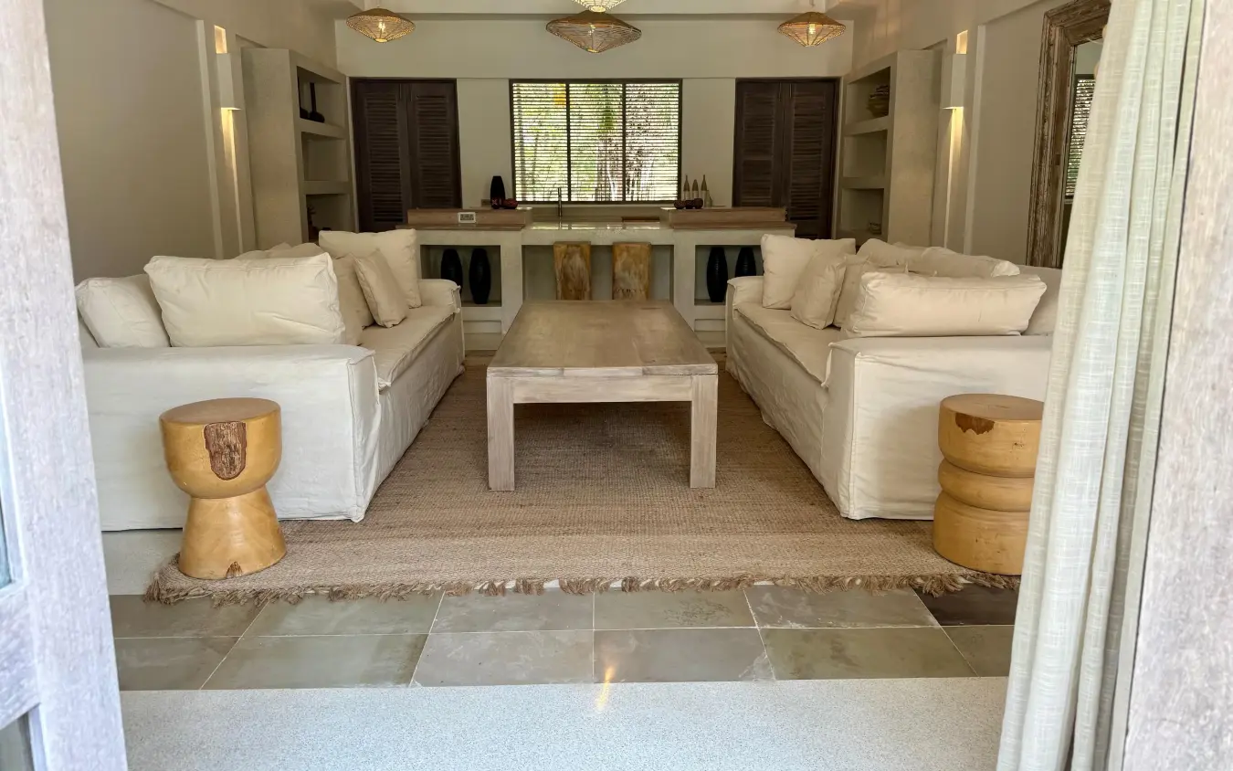 Luxury lounge interior with cream sofas and wooden accent stools, Maya Kobe, Kilifi, Kenya
