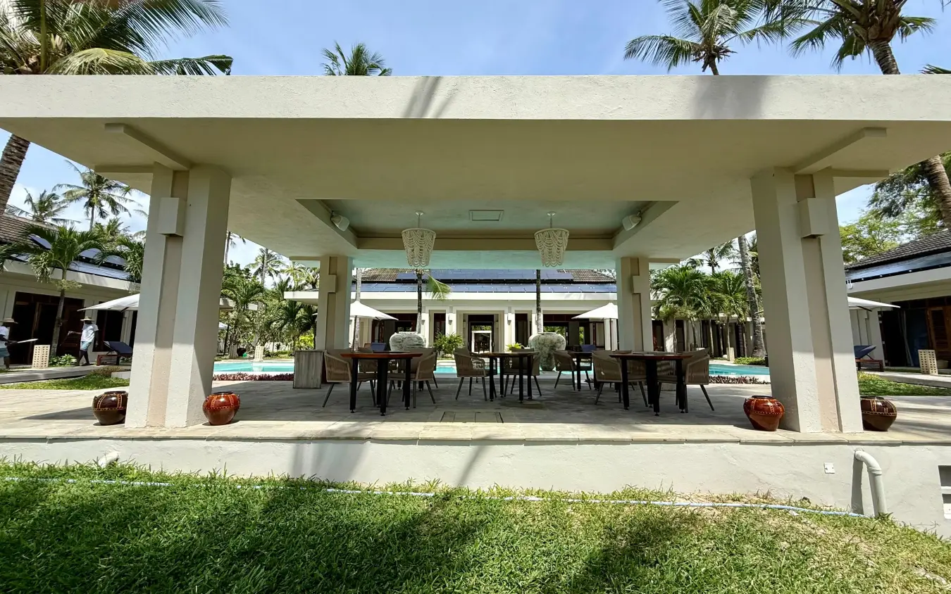 Modern open-air pavilion with dining area overlooking manicured gardens and pool, Maya Kobe, Kilifi, Kenya