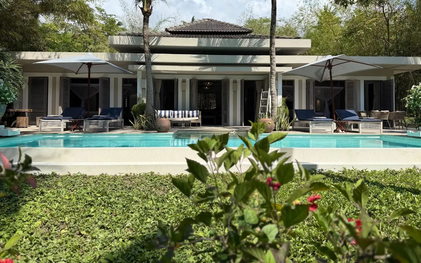 Contemporary pool villa with loungers and shade umbrellas overlooking manicured gardens, Maya Kobe, Kilifi, Kenya