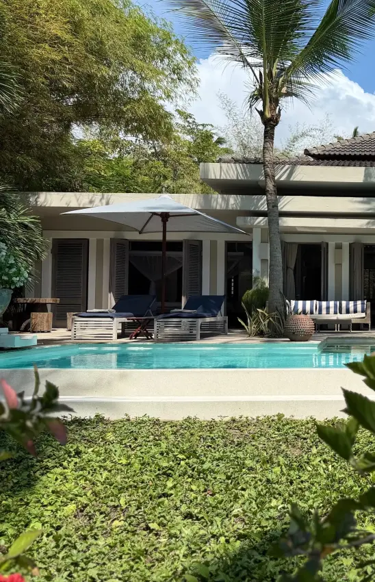 Modern poolside villa with loungers and tropical garden landscaping, Maya Kobe, Kilifi, Kenya