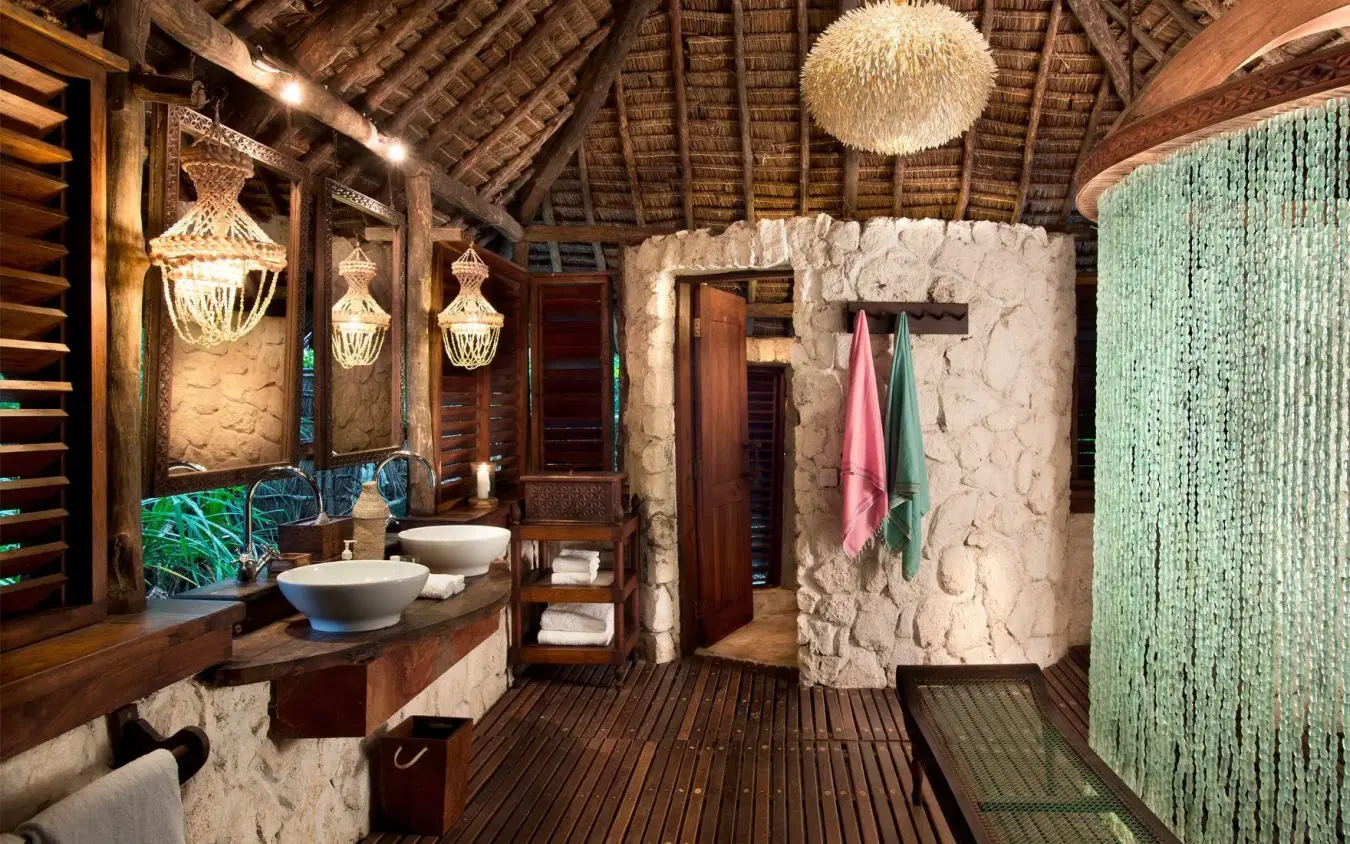 Open-air bathroom with stone walls and wooden beams, Mnemba Island, Zanzibar & Pemba, Tanzania