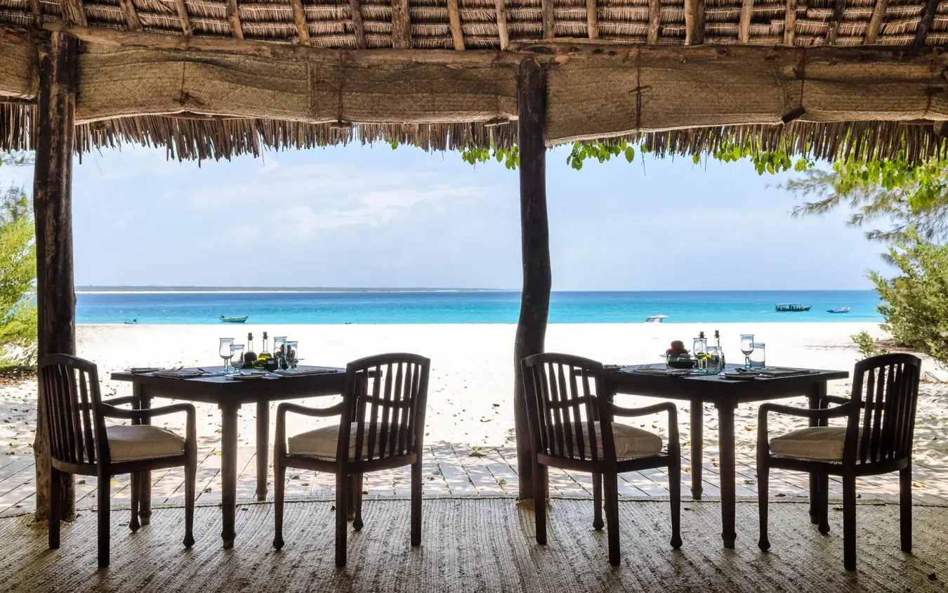 Beachfront dining pavilion with ocean views and boats, Mnemba Island, Zanzibar & Pemba, Tanzania