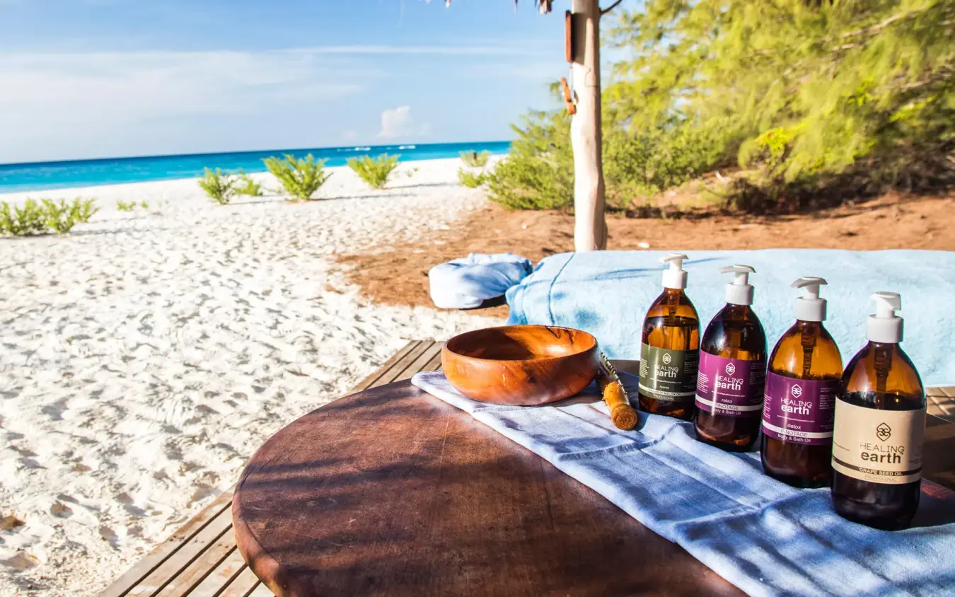 Beach bar setup with beverages overlooking turquoise ocean, Mnemba Island, Zanzibar & Pemba, Tanzania