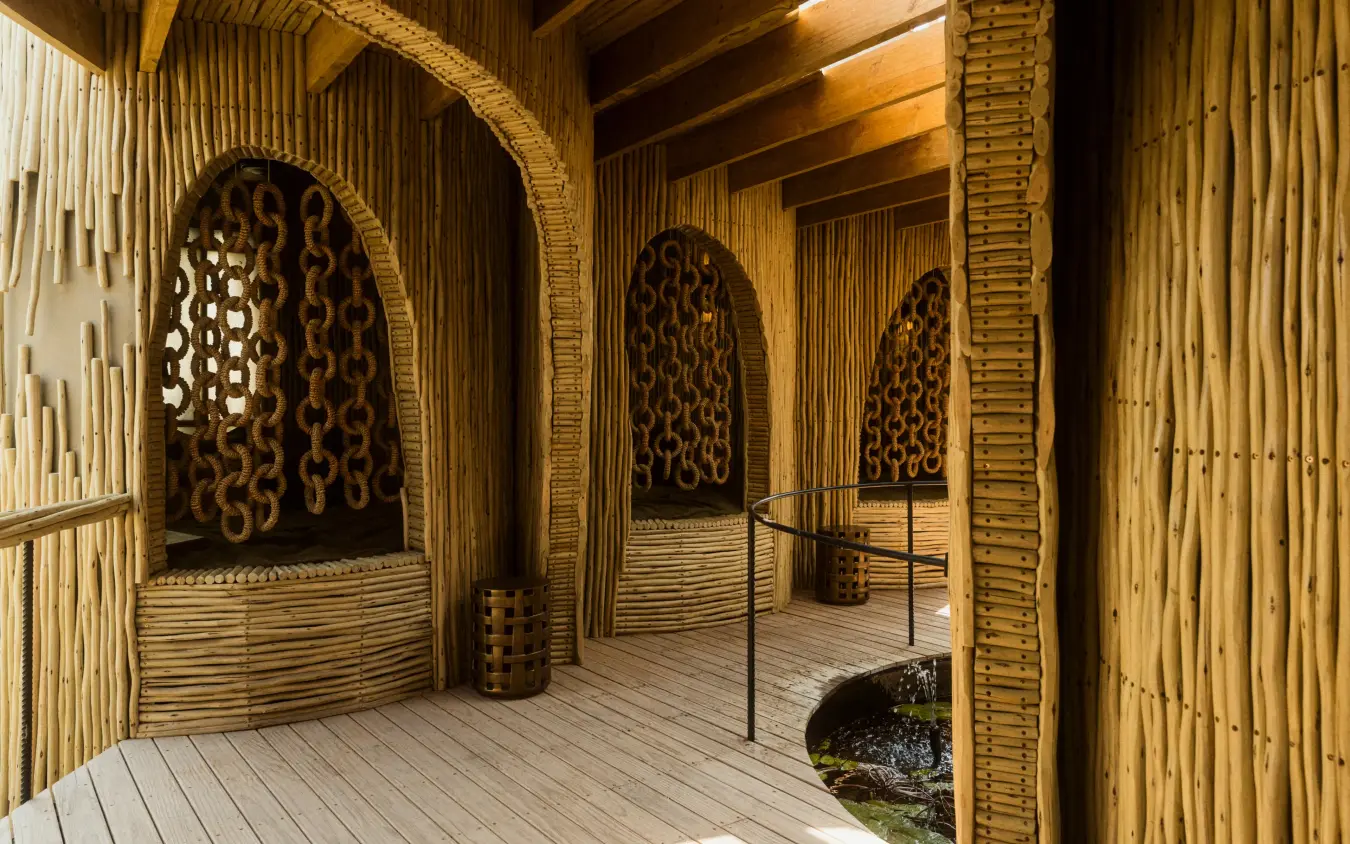 Wooden pavilion with arched doorways and decorative panels, Mombo Camp, The Okavango Delta, Botswana