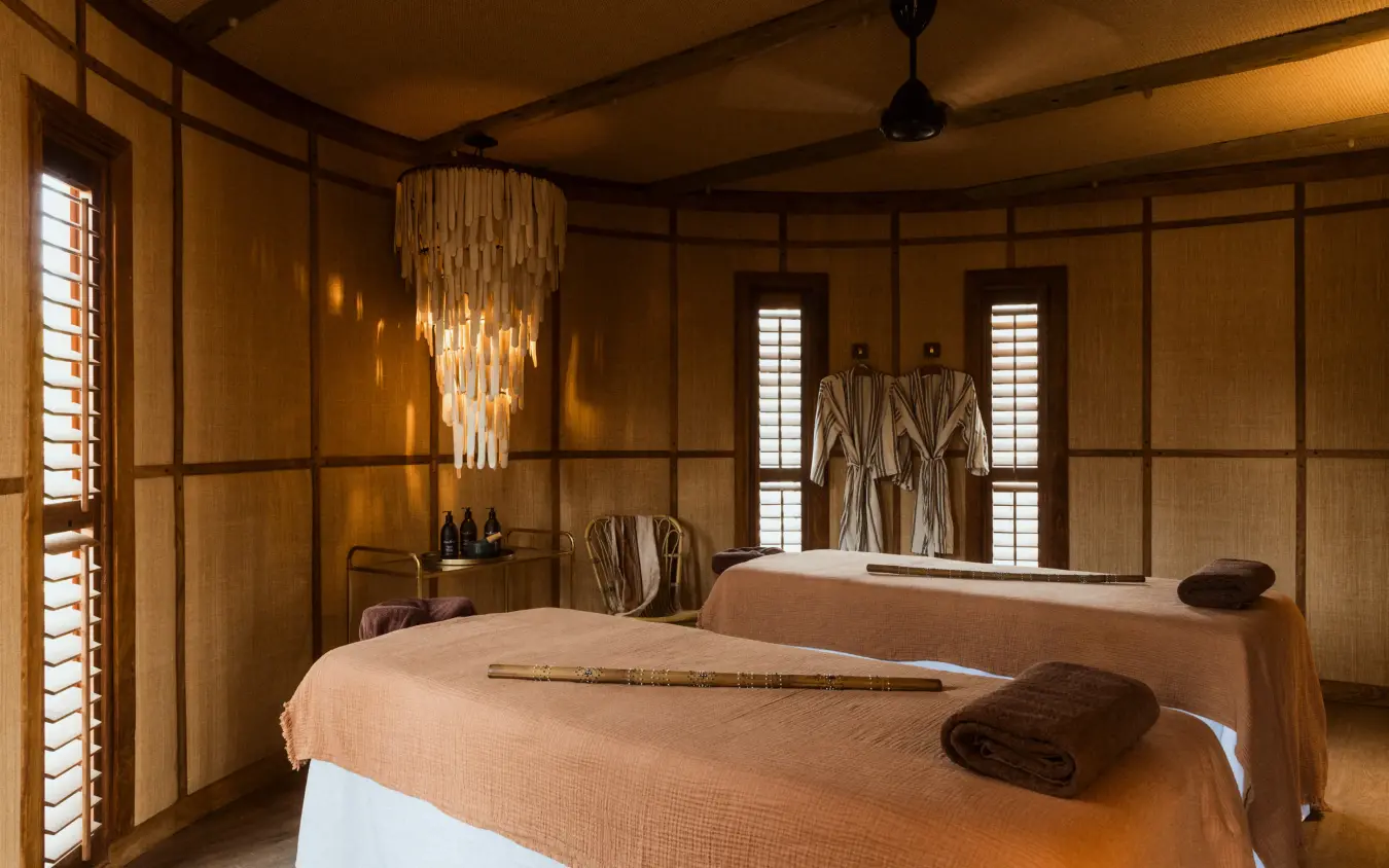 Spa treatment room with twin massage beds and wooden interior, Mombo Camp, The Okavango Delta, Botswana