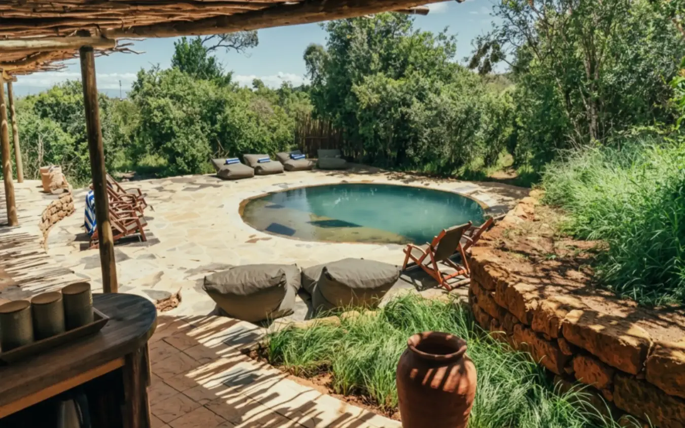 Natural hot spring pool with loungers and rustic pergola shaded seating area, Moon’s Camp, Laikipia Highlands, Kenya