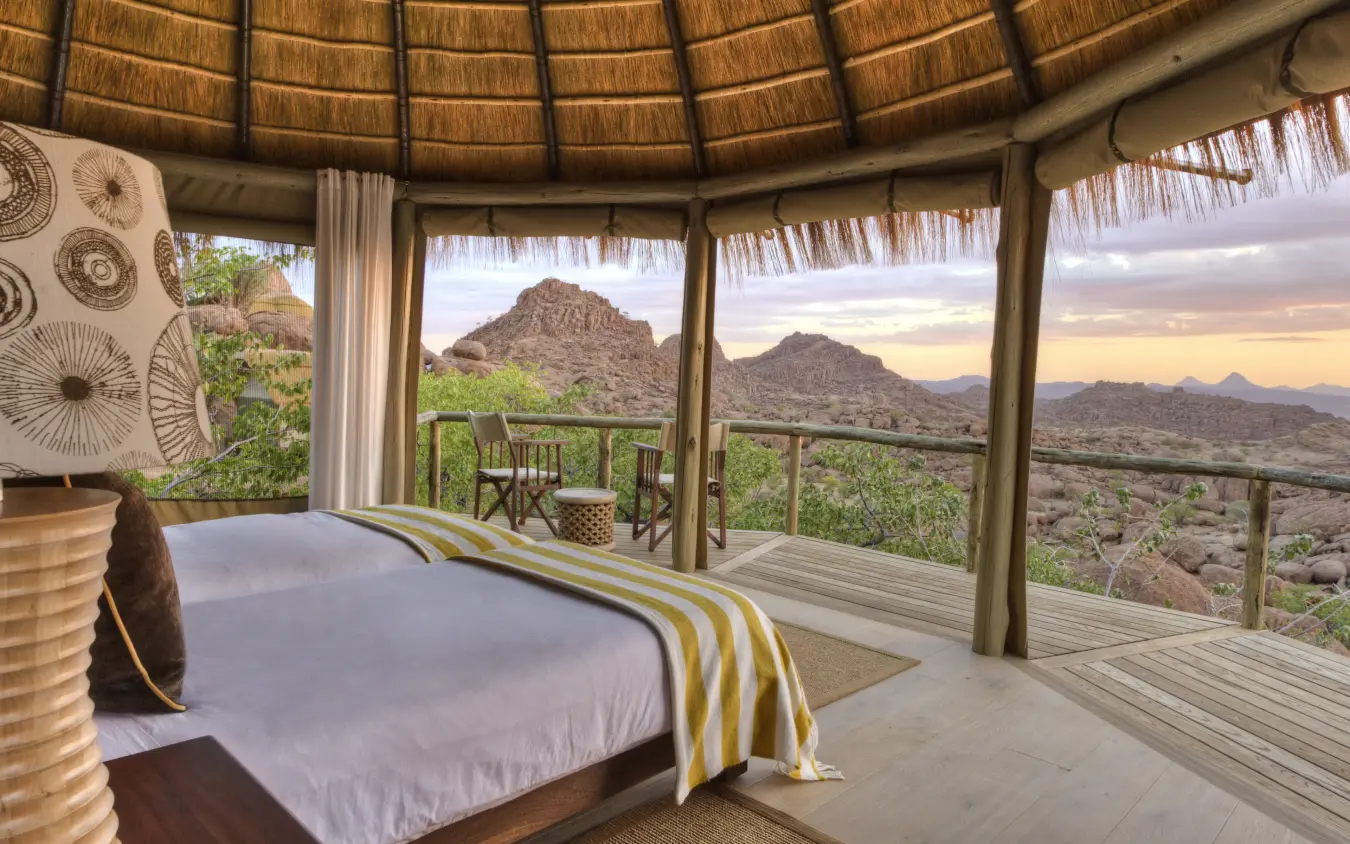 Bedroom suite with panoramic desert mountain views at sunset, Mowani Mountain Camp, Damaraland, Namibia