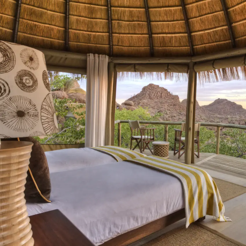 Bedroom suite with panoramic desert mountain views at sunset, Mowani Mountain Camp, Damaraland, Namibia