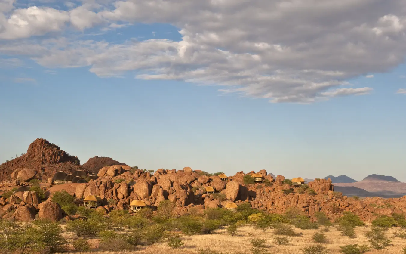 Rocky granite outcrops with scattered acacia trees in arid landscape, Mowani Mountain Camp, Damaraland, Namibia
