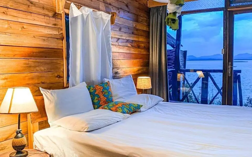 Waterfront bedroom with wooden walls and lake views, Mutanda Lake Resort, Lake Mutanda, Uganda
