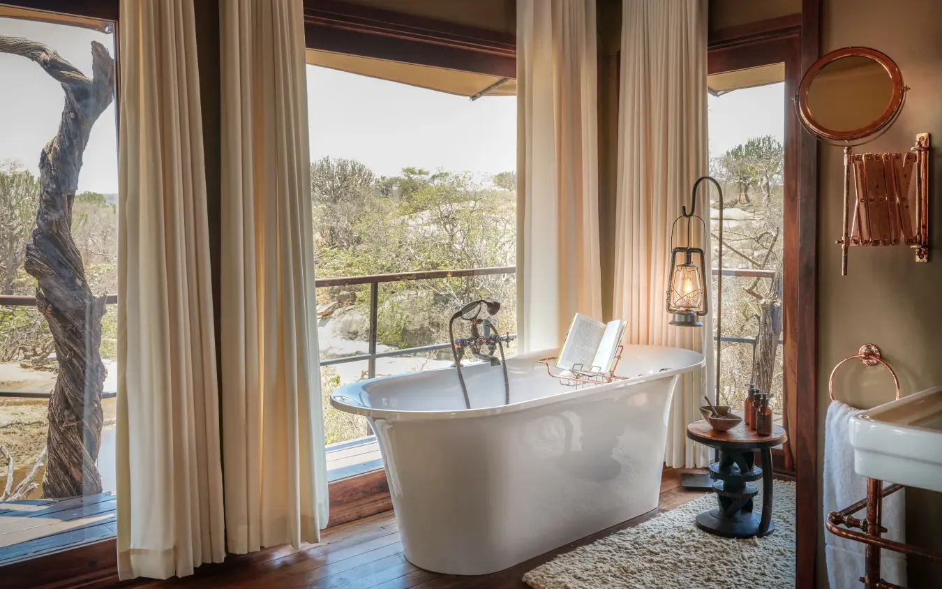 Freestanding bathtub with expansive wildlife vista windows, Mwiba Lodge, Serengeti National Park, Tanzania