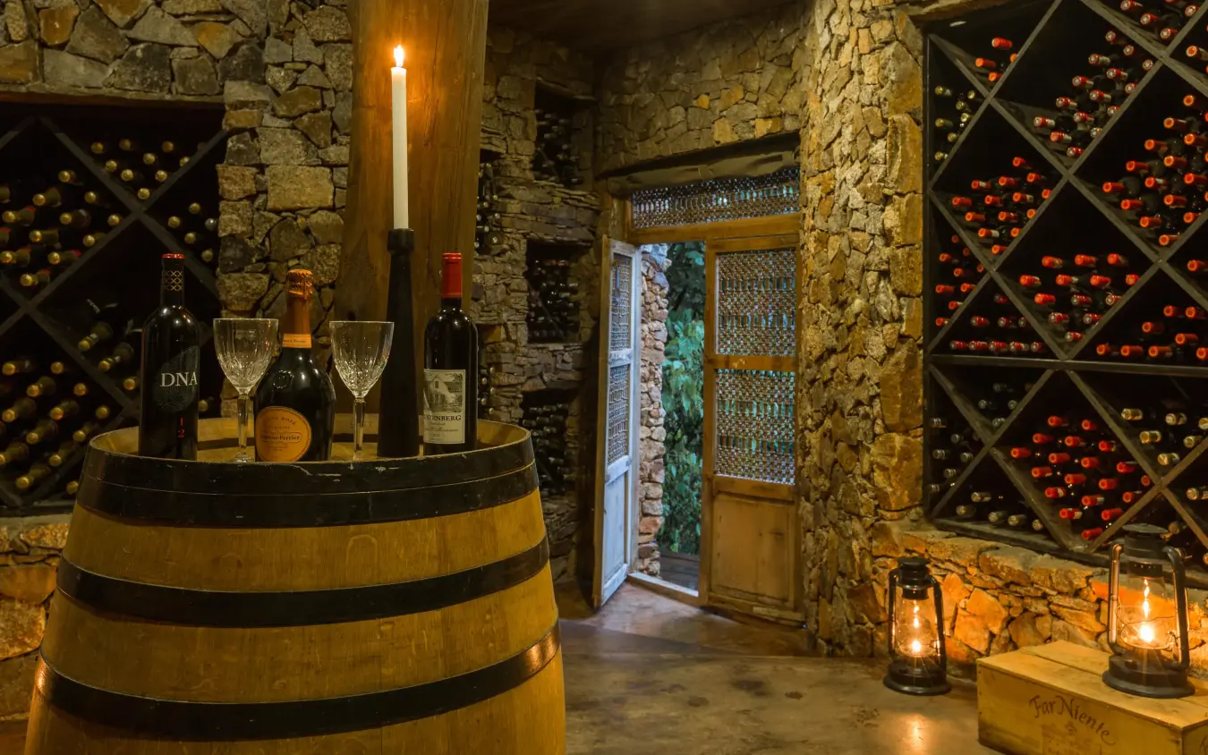 Wine cellar with barrel table and bottle storage racks, Mwiba Lodge, Serengeti National Park, Tanzania