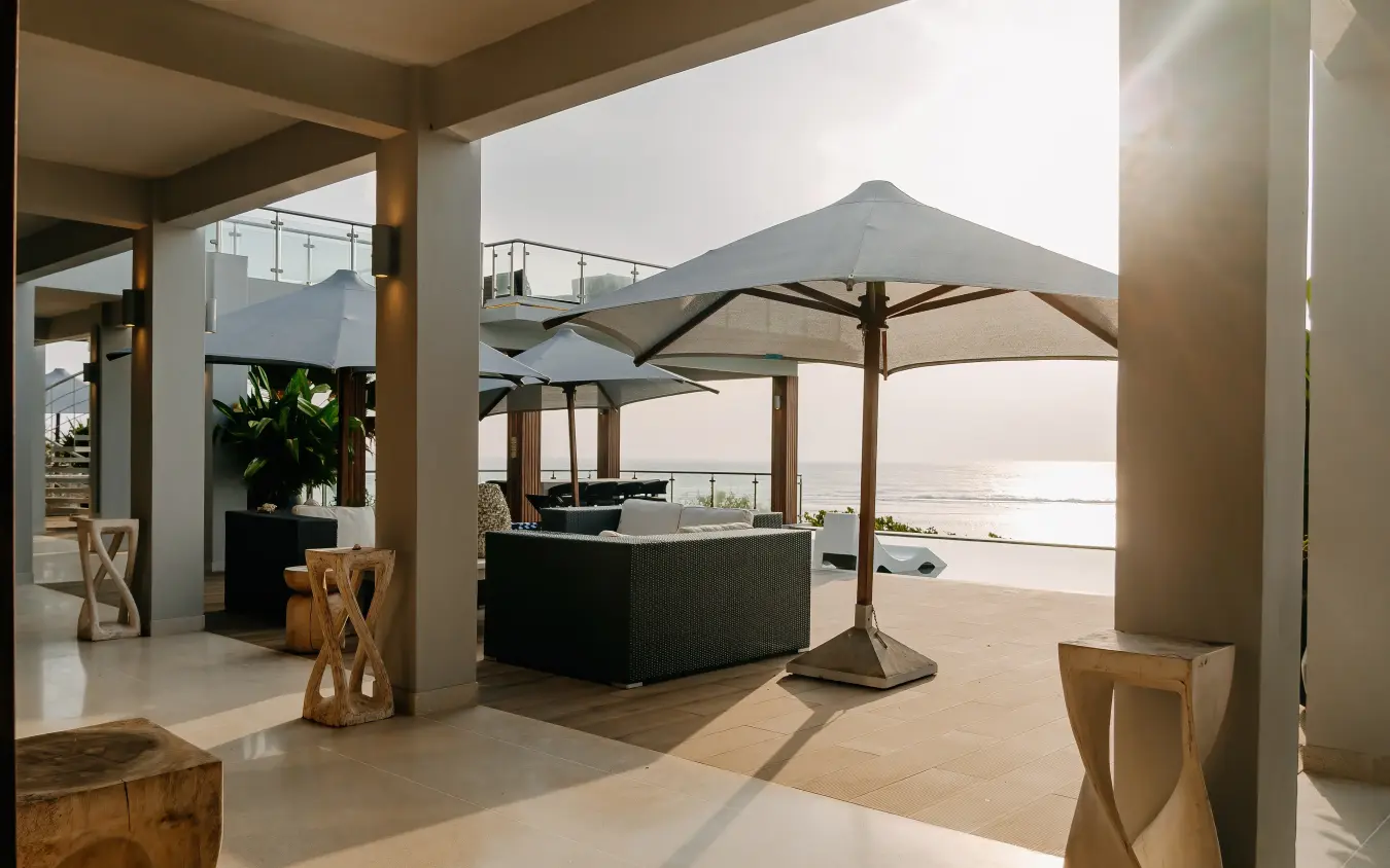 Beachfront deck with umbrellas and ocean views at sunset, My Amani, Kilifi, Kenya