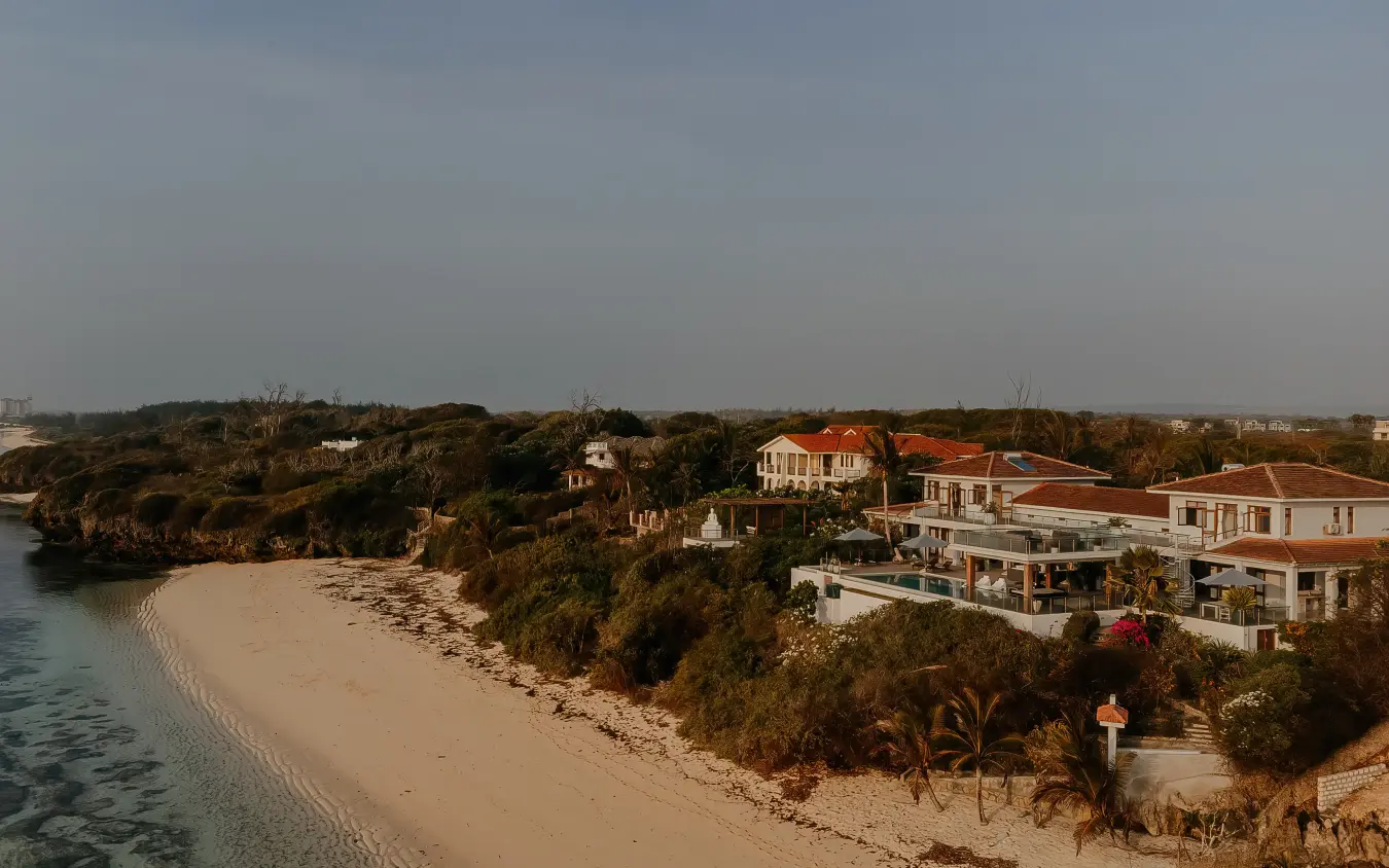Beachfront villas with terracotta roofs overlooking sandy cove and turquoise water, My Amani, Kilifi, Kenya