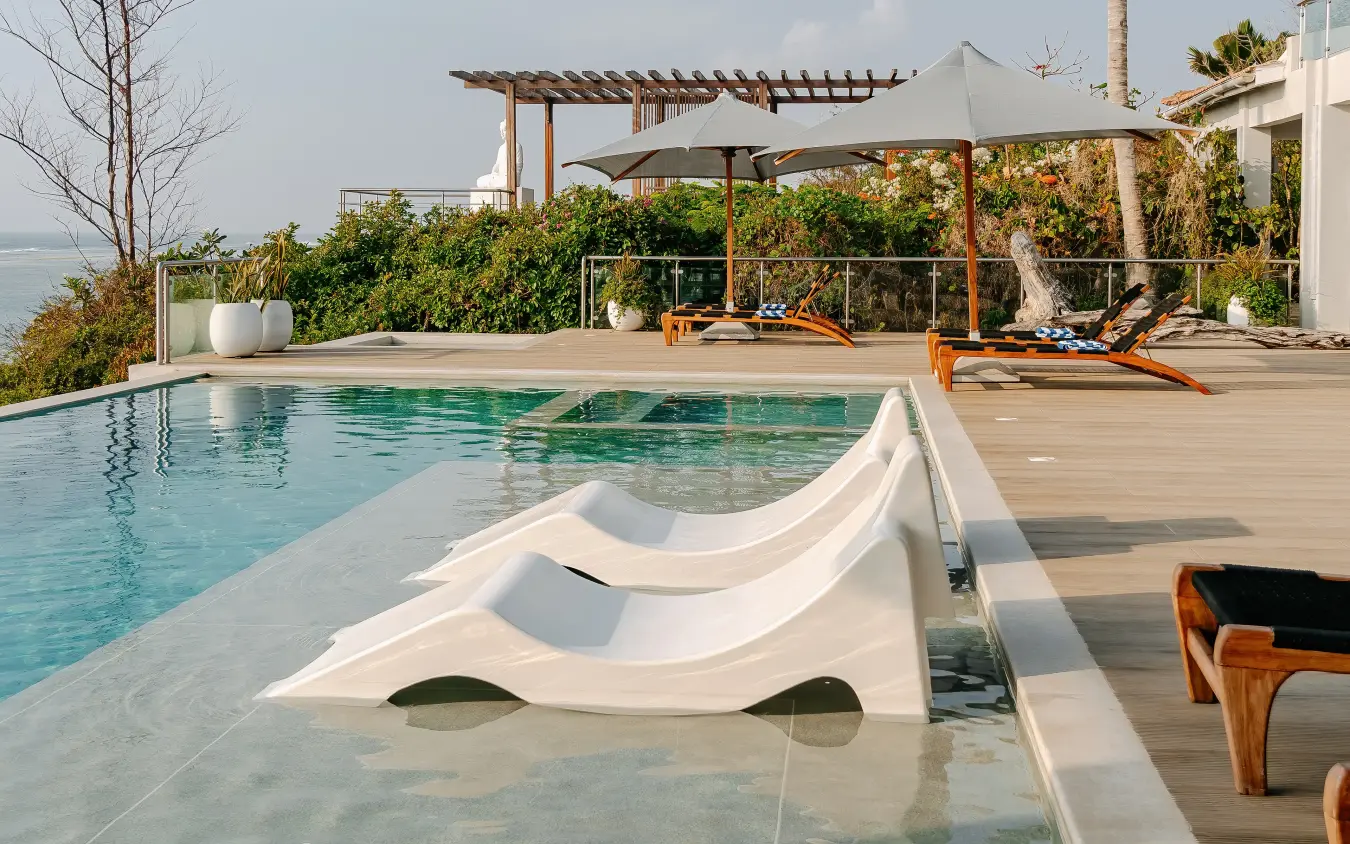 Poolside loungers with ocean view and wooden pergola structures, My Amani, Kilifi, Kenya
