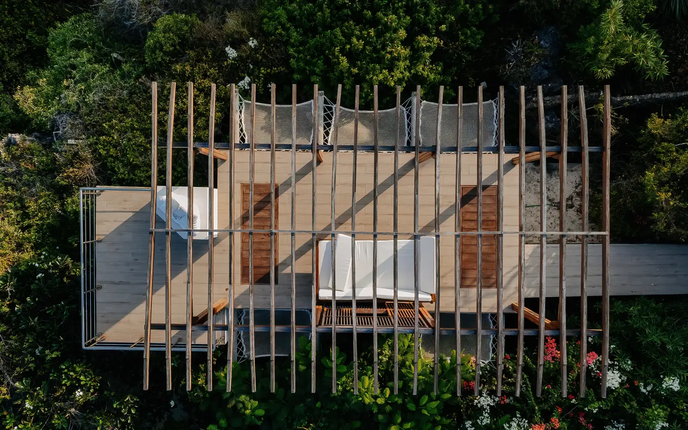 Aerial view of modern wooden deck structure surrounded by forest canopy, My Amani, Kilifi, Kenya