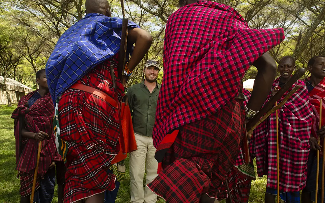 Tourist meeting with Maasai warriors in traditional dress, Mysigio Camp, Ngorongoro Crater, Tanzania