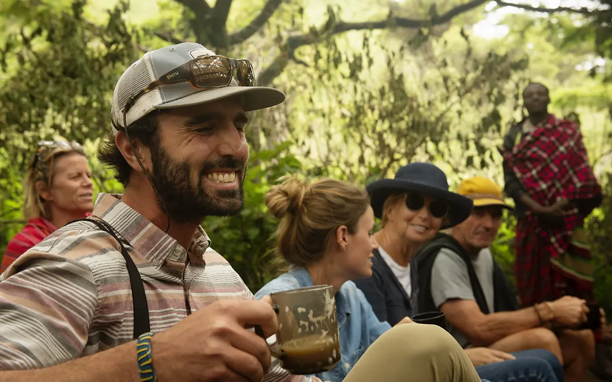 Guests gathered outdoors enjoying beverages and conversation, Mysigio Camp, Ngorongoro Crater, Tanzania