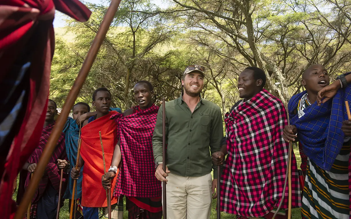 Group of people walking together in acacia woodland, Mysigio Camp, Ngorongoro Crater, Tanzania