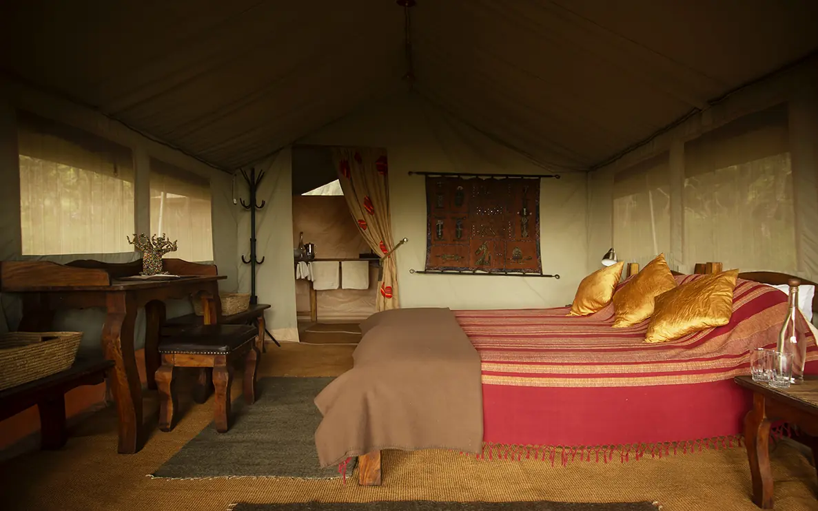 Safari tent interior with bed, desk, and canvas furnishings, Mysigio Camp, Ngorongoro Crater, Tanzania