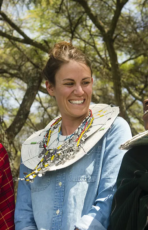 Woman with local guides wearing traditional beaded jewelry, Mysigio Camp, Ngorongoro Crater, Tanzania
