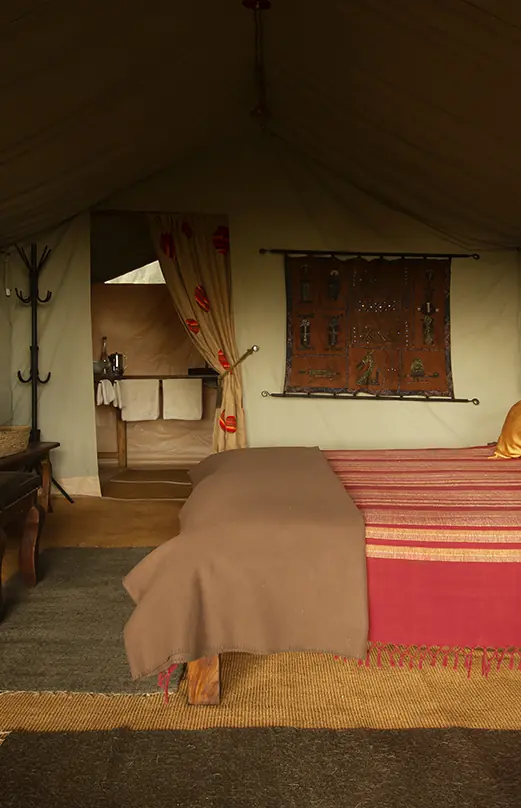 Safari tent interior with bed, desk, and canvas furnishings, Mysigio Camp, Ngorongoro Crater, Tanzania