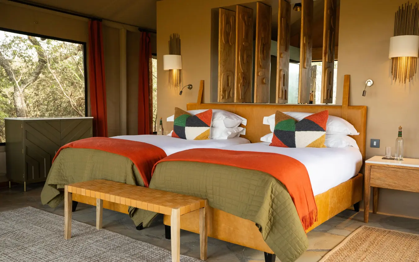 Bedroom with twin beds, wooden headboards, and large window, Naboisho Camp, Maasai Mara, Kenya