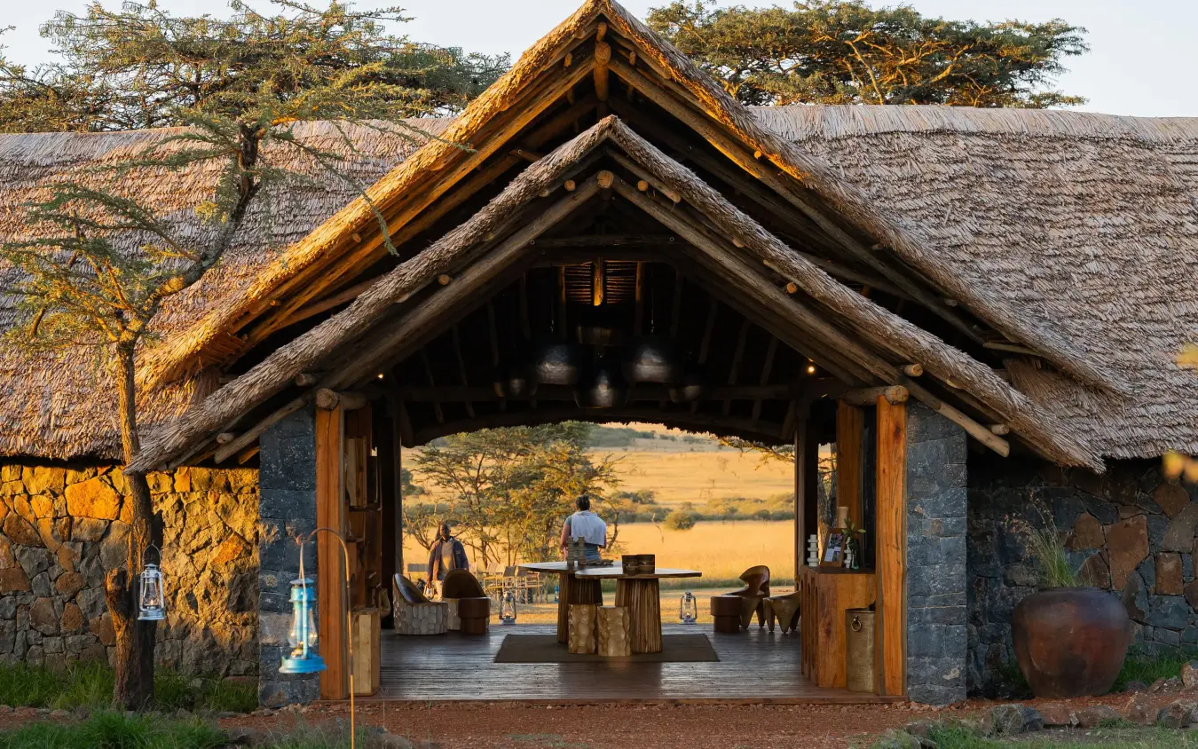Thatched-roof lodge entrance with savanna vista beyond, Naboisho Camp, Maasai Mara, Kenya