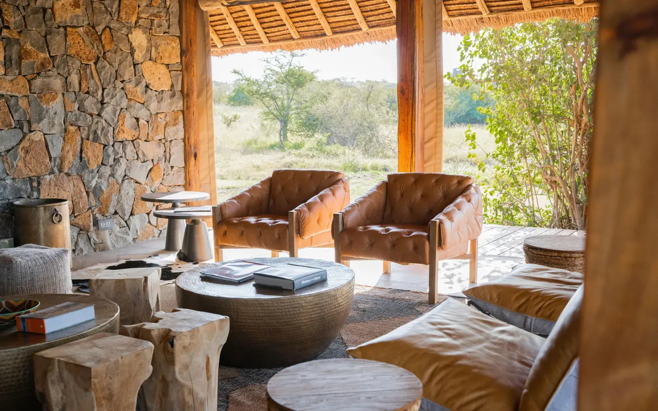 Open-air lounge with leather seating and savanna views, Naboisho Camp, Maasai Mara, Kenya