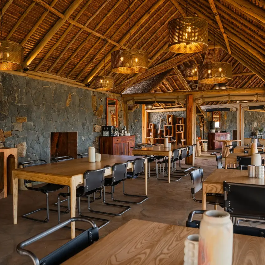 Interior view of spacious lodge lounge with wooden beams, Naboisho Camp, Maasai Mara, Kenya