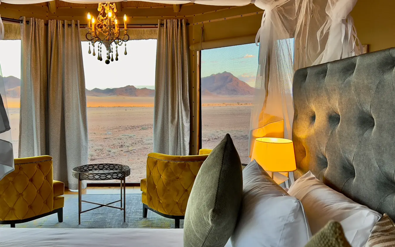 Luxury bedroom tent with mountain views and desert landscape at sunset, Namib Outpost, Sossusvlei, Namibia