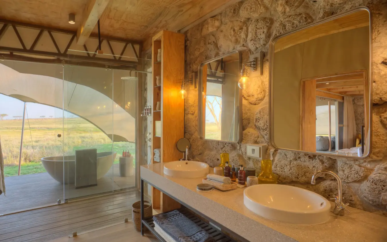 Luxury bathroom with dual sinks and expansive landscape views, Namiri Plains, Serengeti National Park, Tanzania