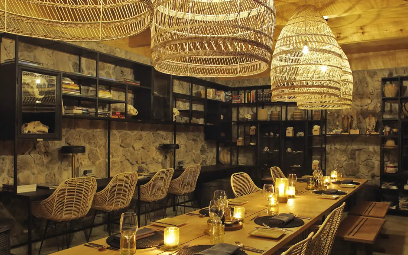 Fine dining restaurant with woven pendant lights and display shelving, Namiri Plains, Serengeti National Park, Tanzania