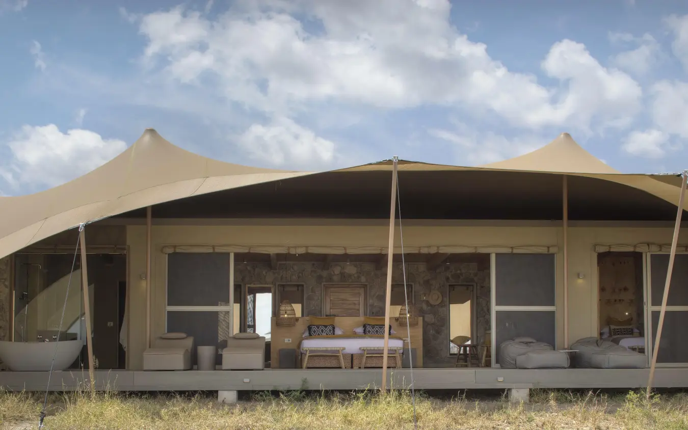 Canvas tent accommodation with wooden deck and savanna landscape, Namiri Plains, Serengeti National Park, Tanzania